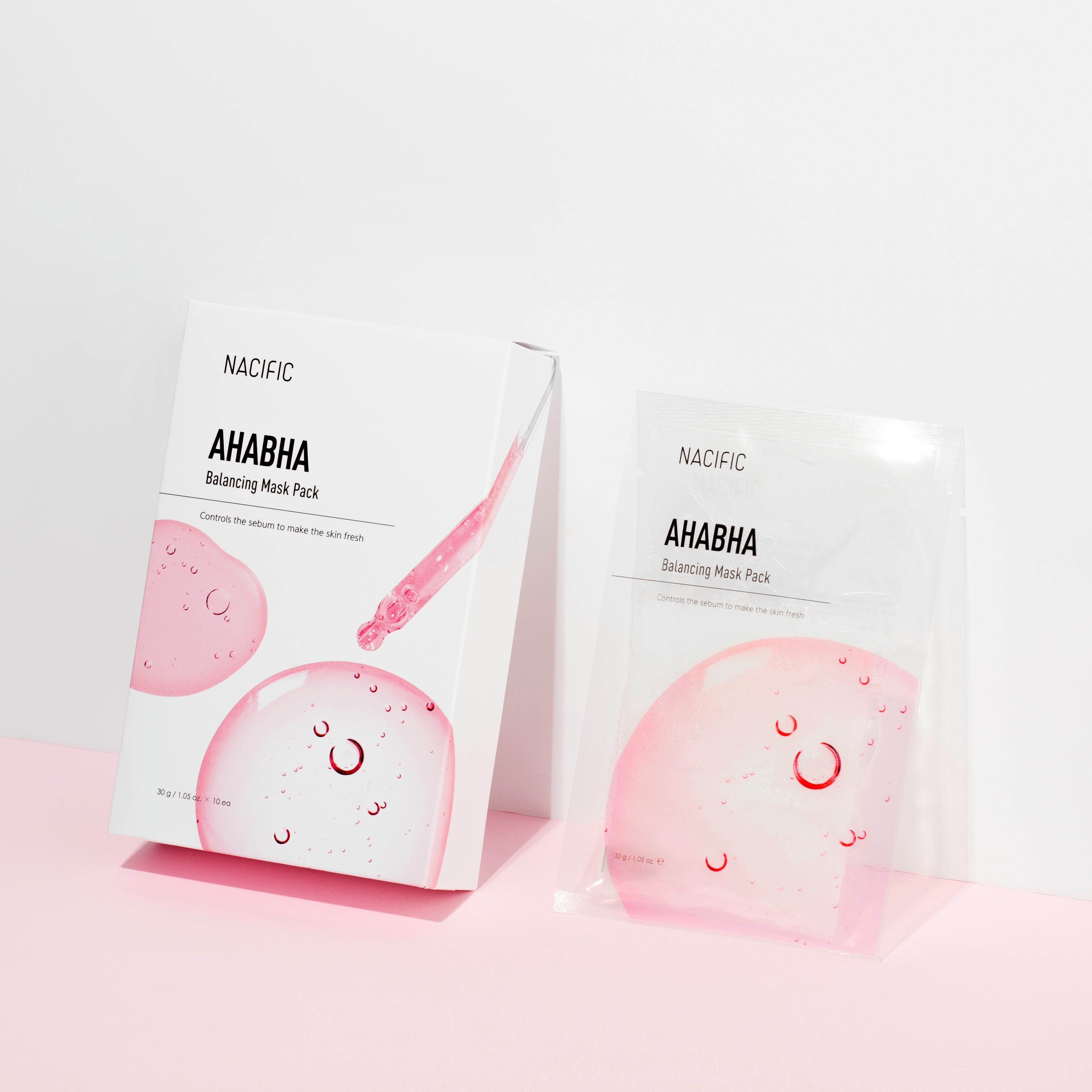 Two AHAVA sheet masks on a pink and white background