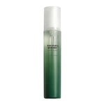 Green skincare bottle with white cap on a white background