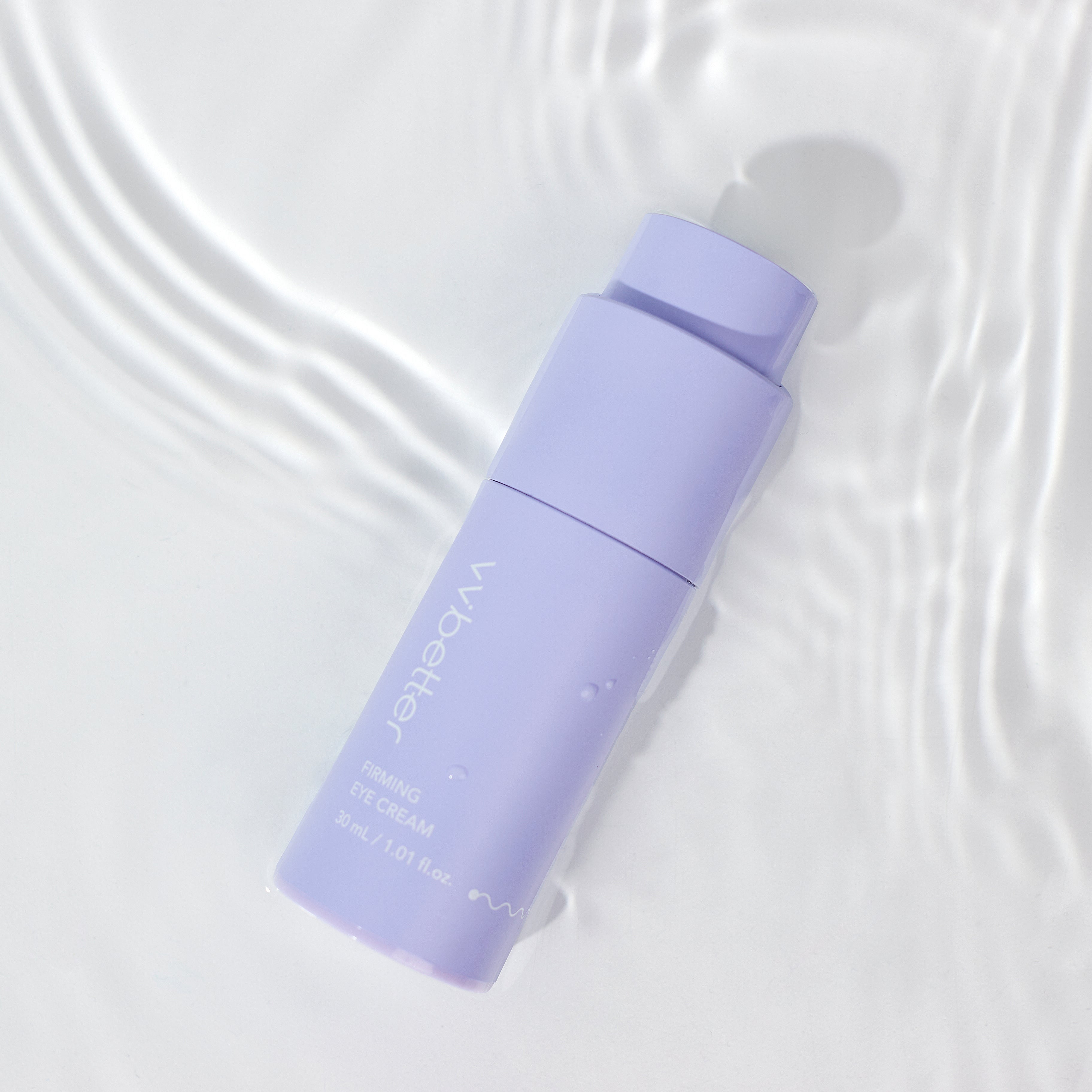 Purple skincare bottle on a textured white background